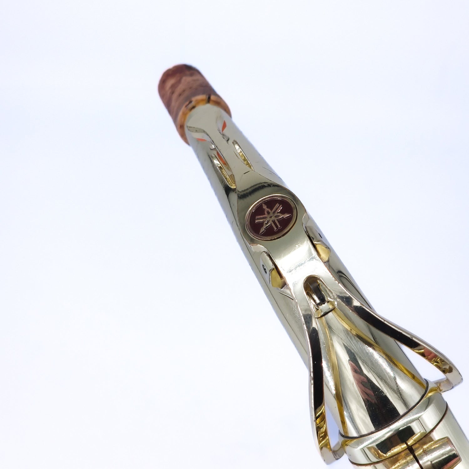 closeup of Yamaha logo on alto sax neck