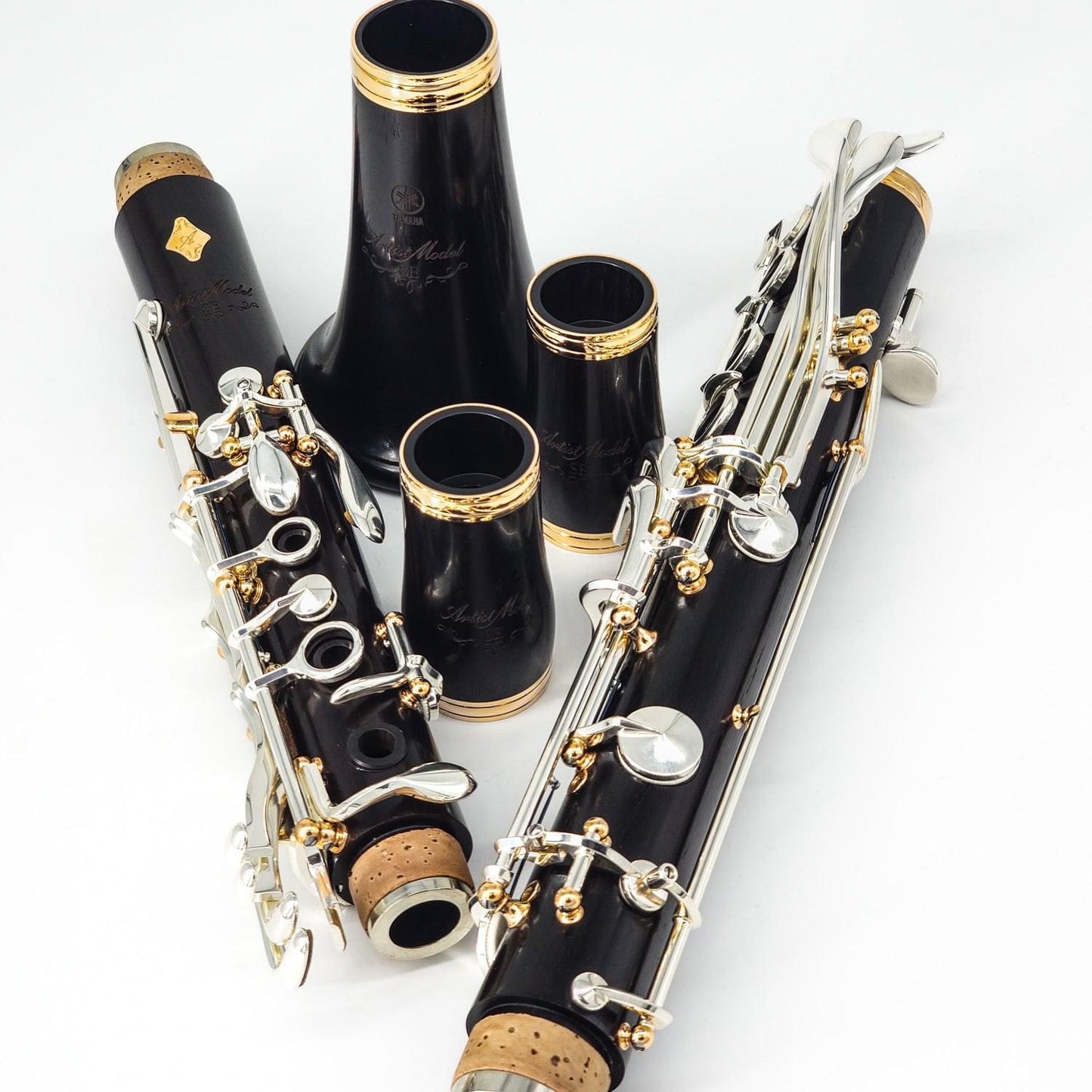 Yamaha SE Artist A clarinet, disassembled into its individual joints, arranged on a white background