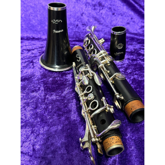 Selmer Paris Presence clarinet, disassembled, laying on purple velvet background
