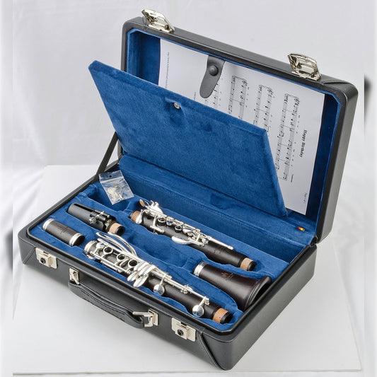 Uebel Advantage-L clarinet laying in its blue-lined attache case with music pocket in the lid (shown open to display a piece of music inside), on a white background