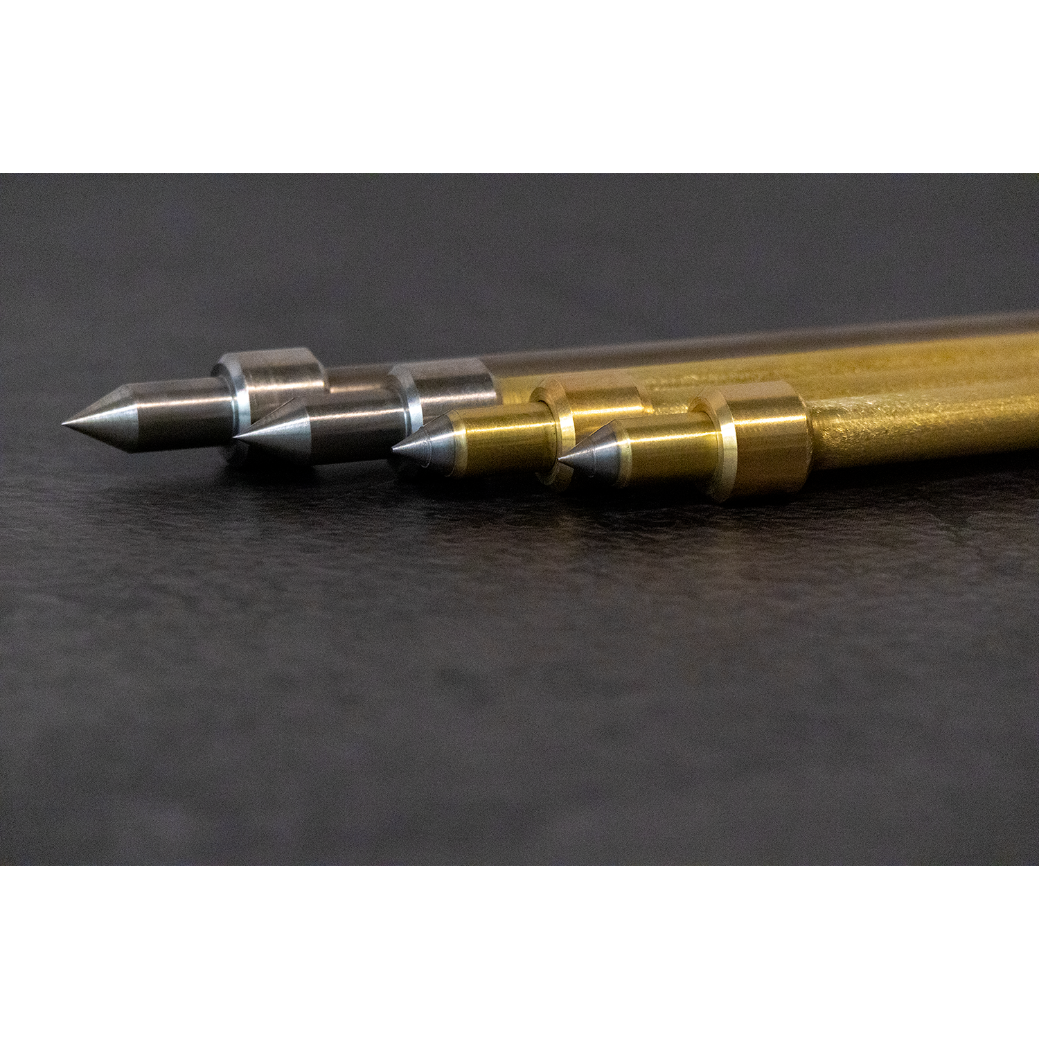 Mitsuke Endpins - tips close up (L to R: titanium, brass & titanium with titanium tip, triple brilliante, quartet)