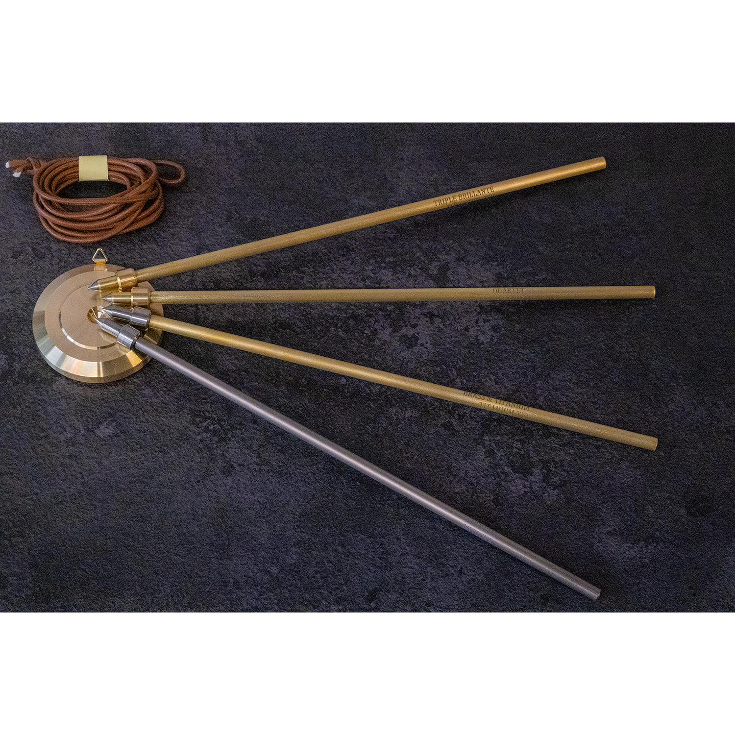 Mitsuke Endpins - pin models fanned out on stopper (top to bottom: triple brilliante quartet, brass & titanium with titanium tip, titanium), with stopper attachment cord
