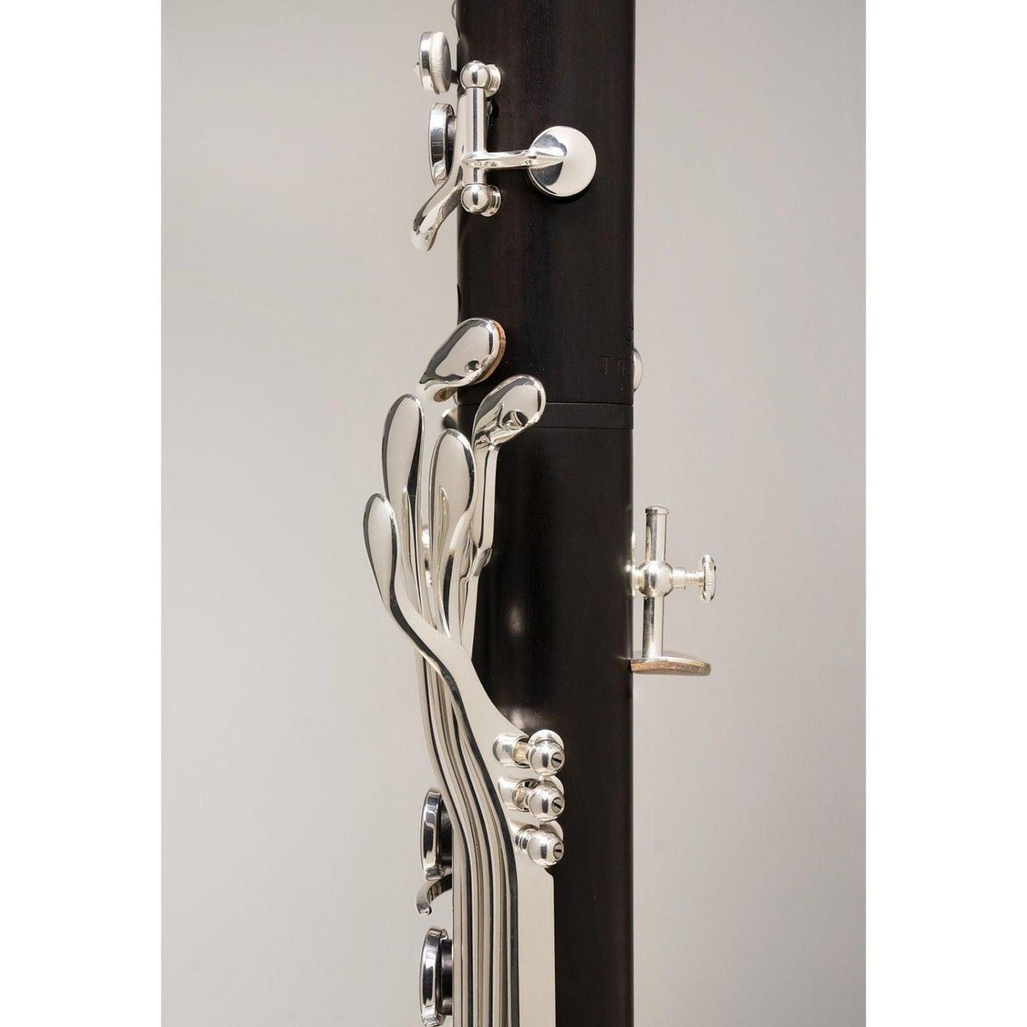 closeup left side view showing left hand pinky key table and black chrome middle joint ring