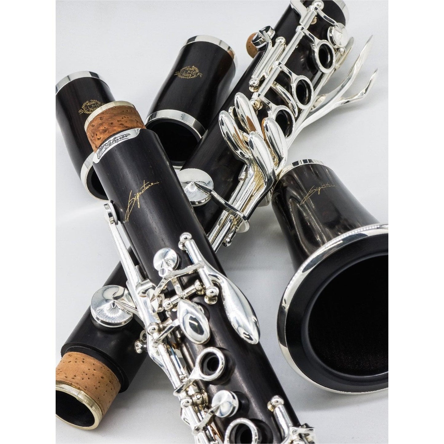 Selmer Signature Bb clarinet disassembled and arranged on a white background