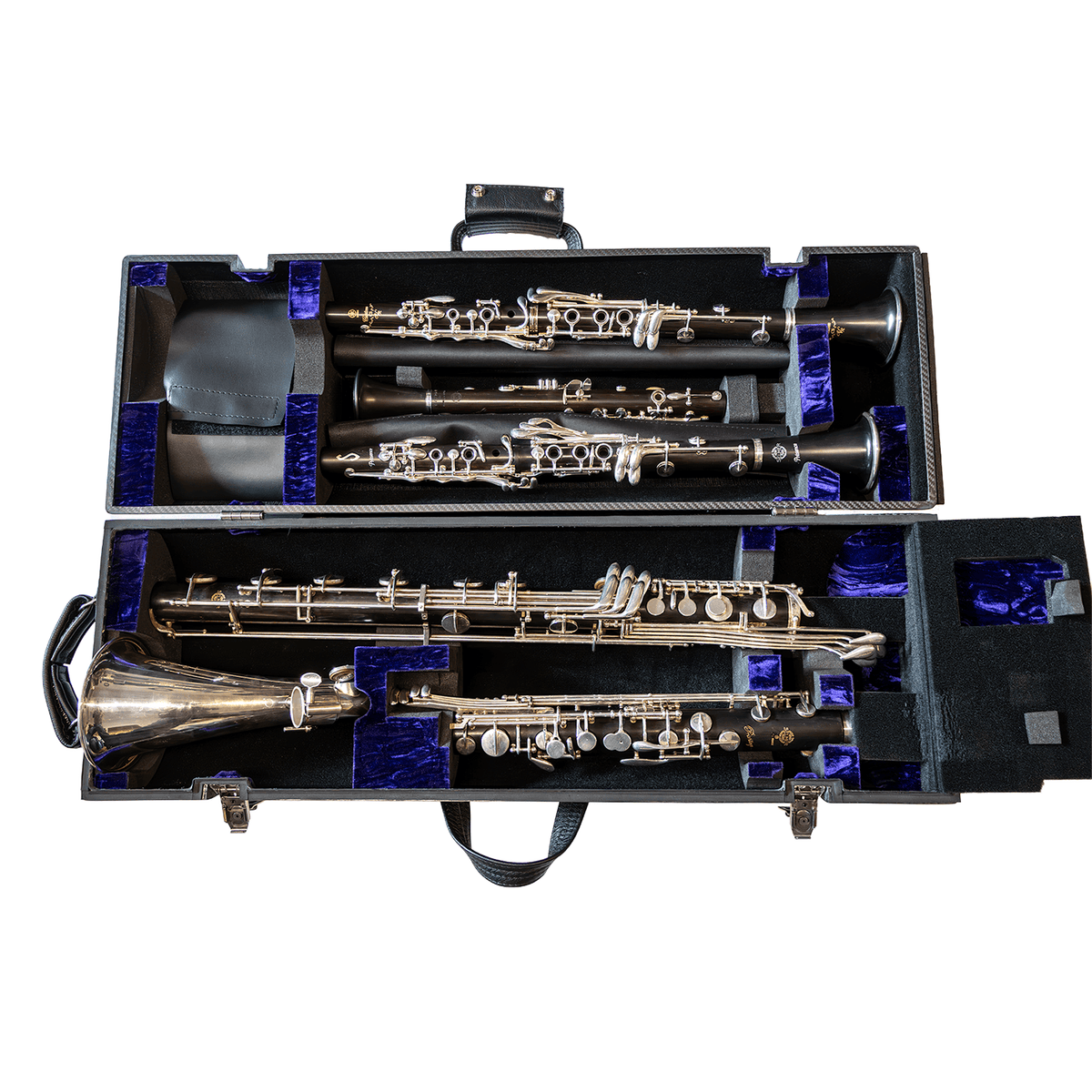 Bass clarinet oval quad case open clamshell view with purple lined foam interior. Selmer Privilege bass clarinet and three sopranos shown. Bass clarinet pinky key securing flap open. Black leather Eb clarinet pouch open, Eb clarinet visible. White background 