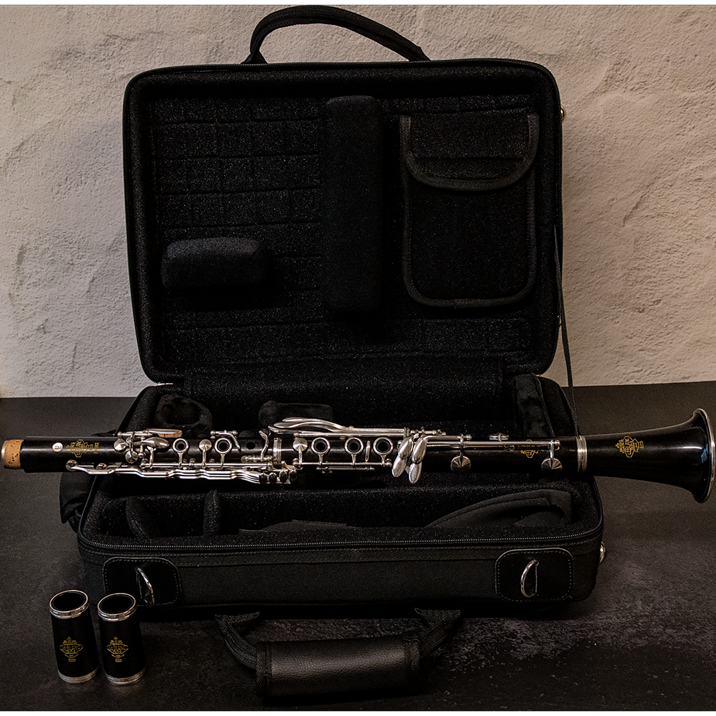 Leblanc L7 A Clarinet - full view - assembled instrument on top of open backpack case - barrels in front of case