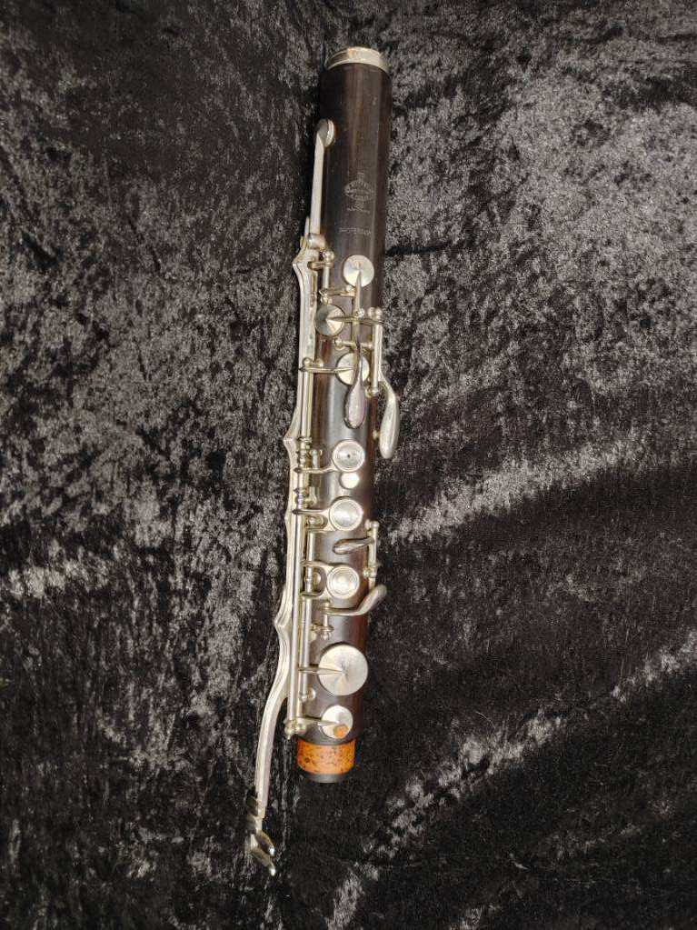 upper joint of Buffet low Eb bass clarinet laying on black velvet