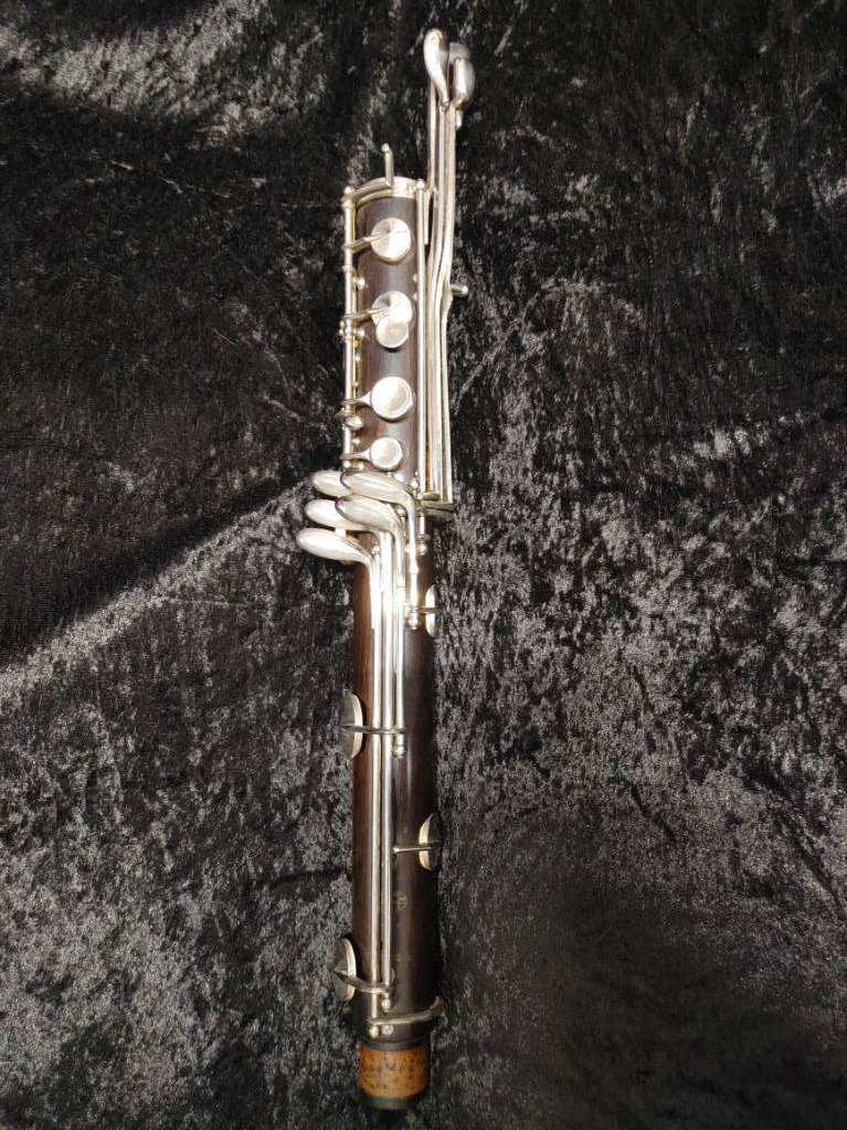 lower joint of Buffet low Eb bass clarinet laying on black velvet