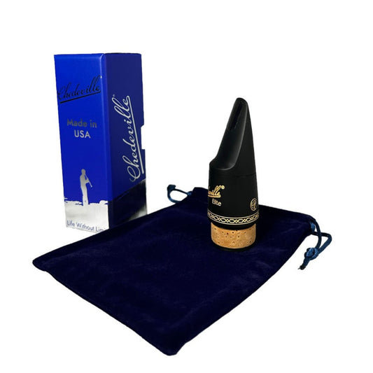 Chedeville elite bass clarinet mouthpiece sitting on its velvet bag next to the blue and silver box it comes in, on a white background
