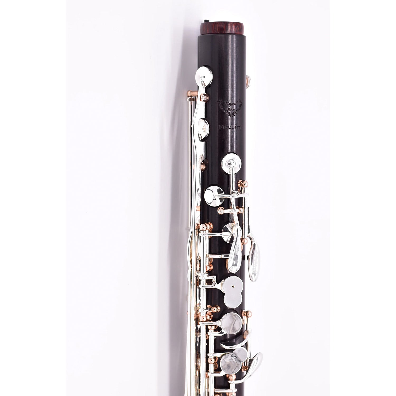 closeup of top joint of the Royal Global Firebird bass clarinet, showcasing the cocobolo neck receiver ring and rose gold posts