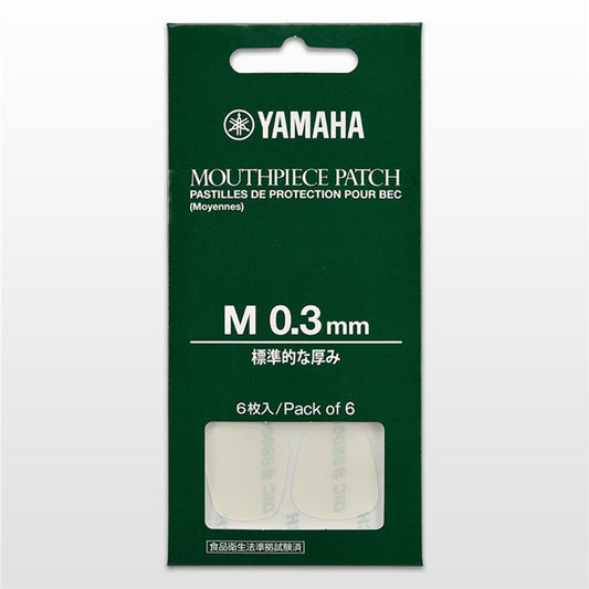 closed package of Yamaha clear mouthpiece patches, in green cardboard packaging, against white background