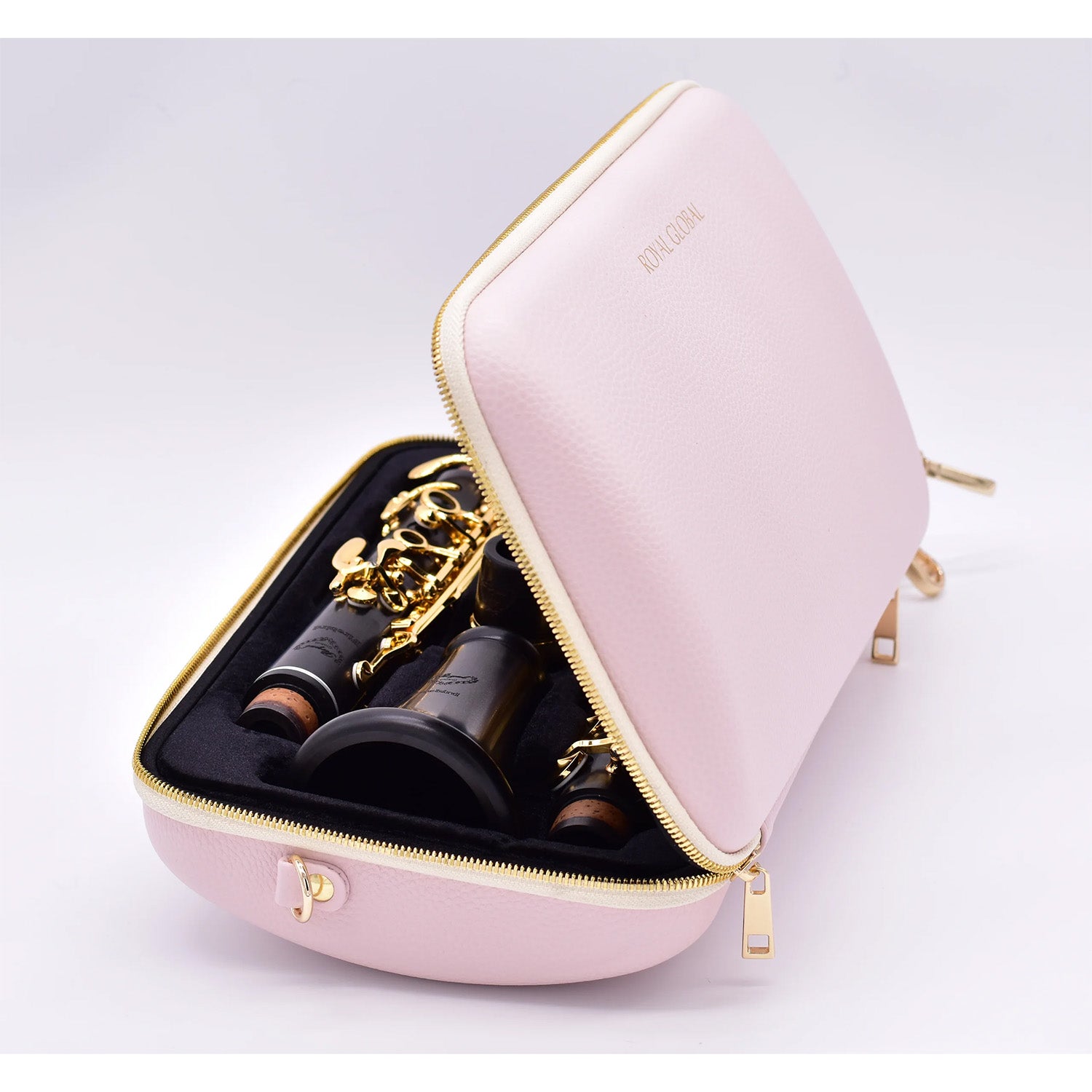 Pink Royal Global single clarinet case, side view, open to show gold-plated Royal Global Firebird clarinet resting inside, on a light gray background